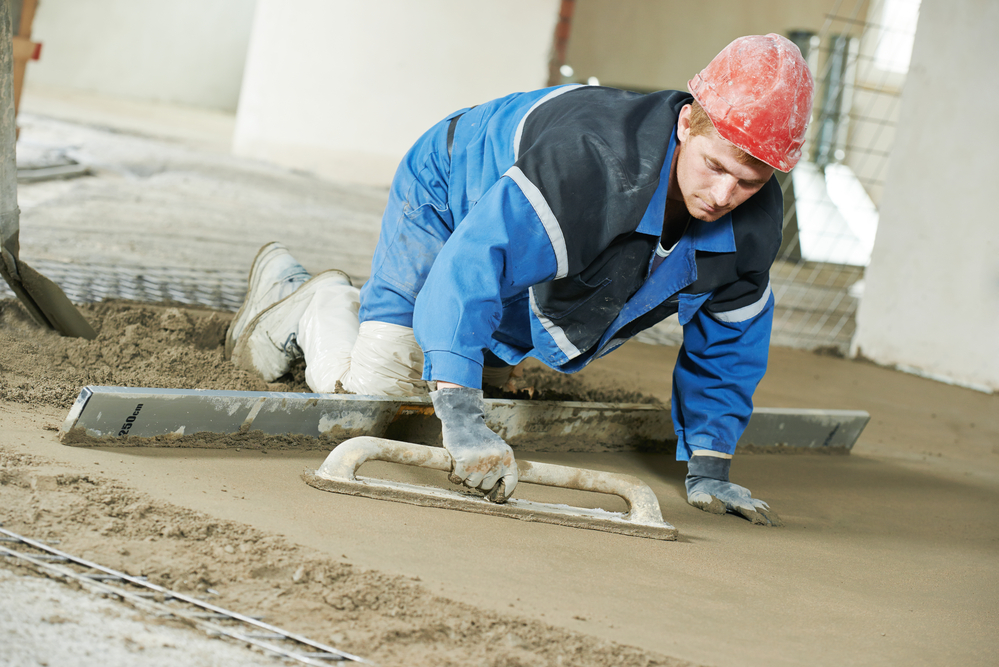 Plasterer concrete worker at floor work concrete floor repair leads
