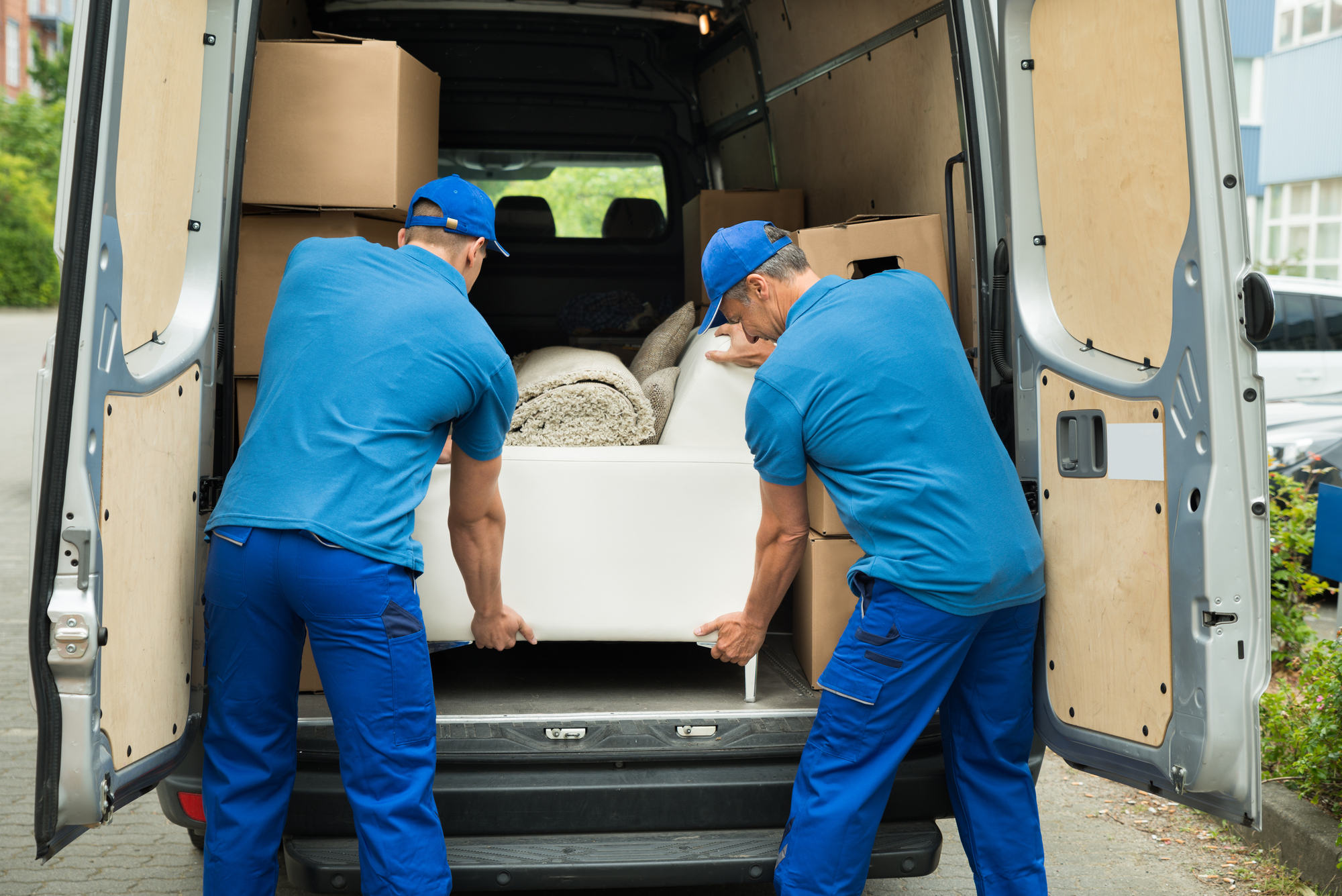 Two Workers Adjusting Sofa In Truck leads for moving companies